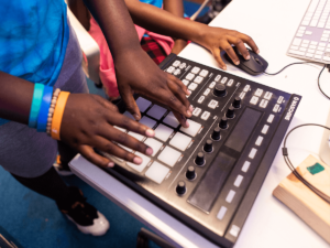 close up of hands using a sound mixer board