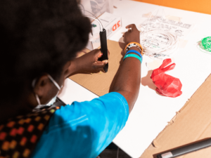 close up of a young person using a cutting tool