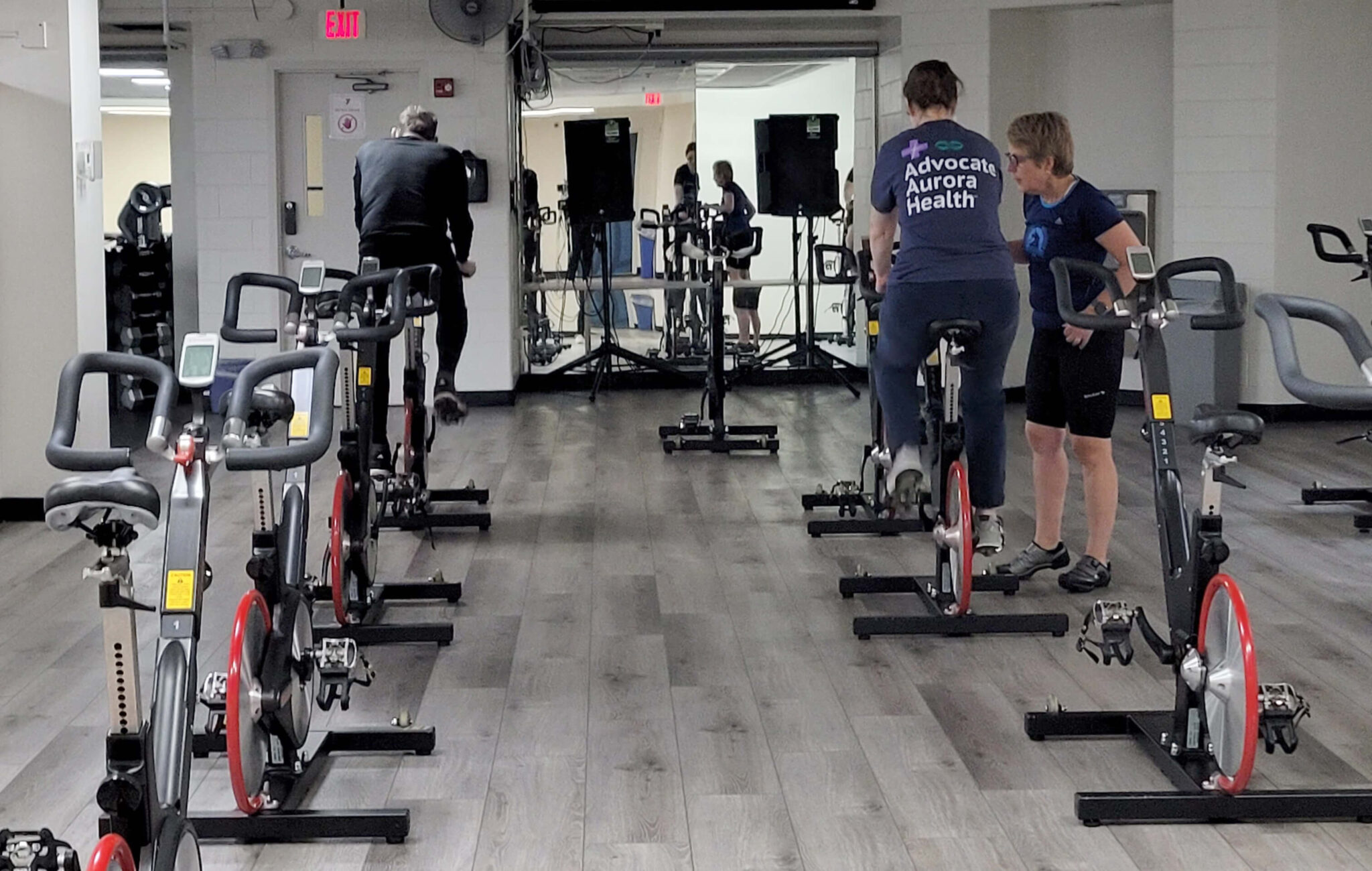 A spin studio with two people on bikes.