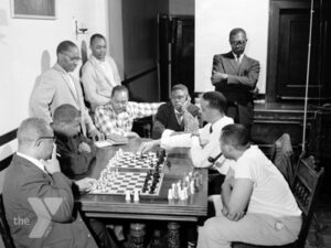 A group of Black men playing chess.