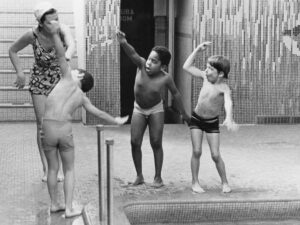 A group of children taking a swim lesson