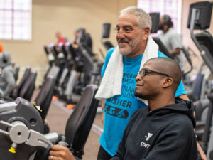 Two people using the fitness center.