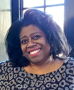 A headshot of L Tucker