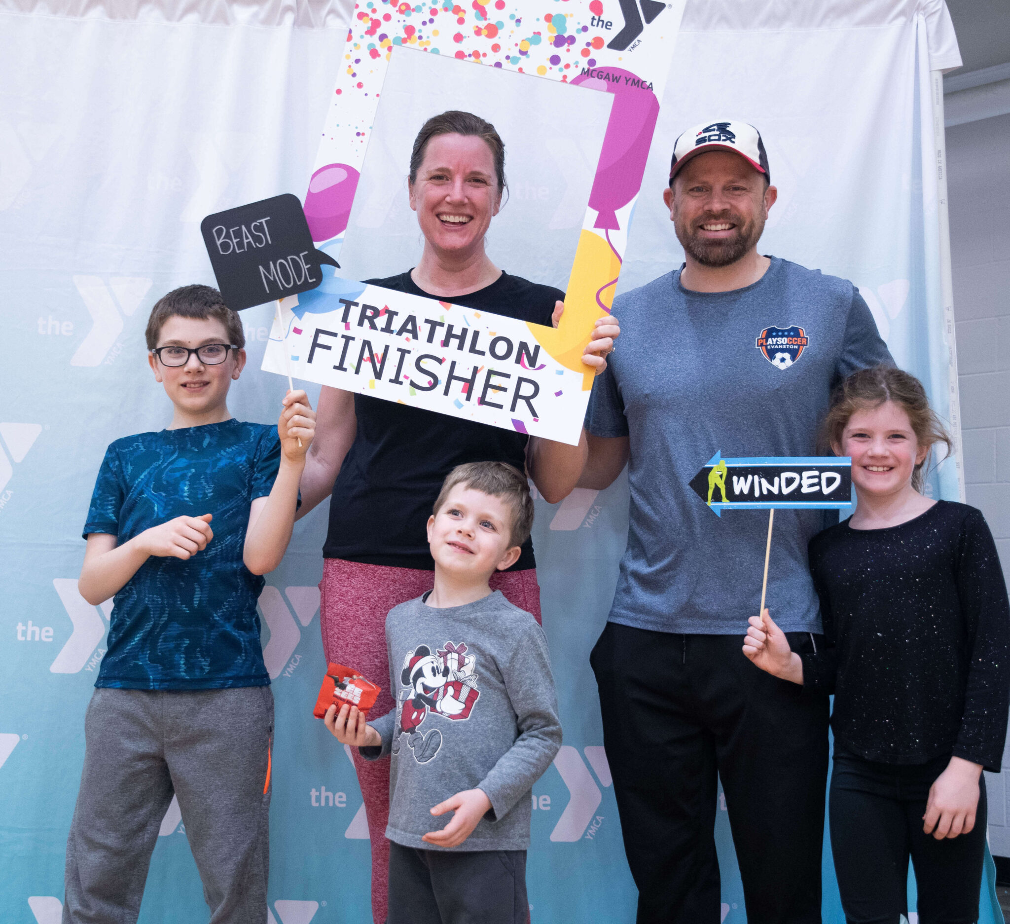 A family smiling after finishing the McGaw Y triathlon