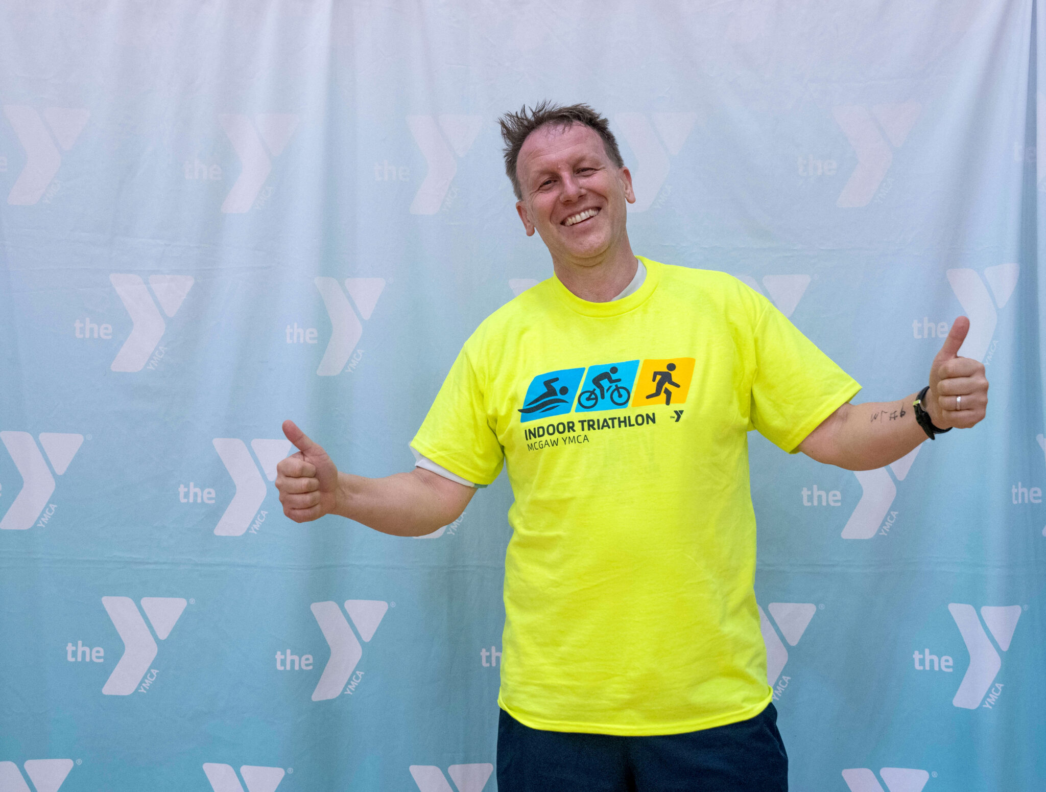 A person smiling with thumbs up after finishing the McGaw Y triathlon