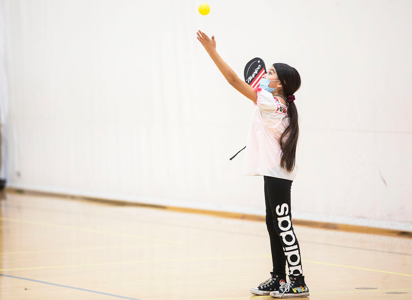 A young person playing pickleball at the YMCA