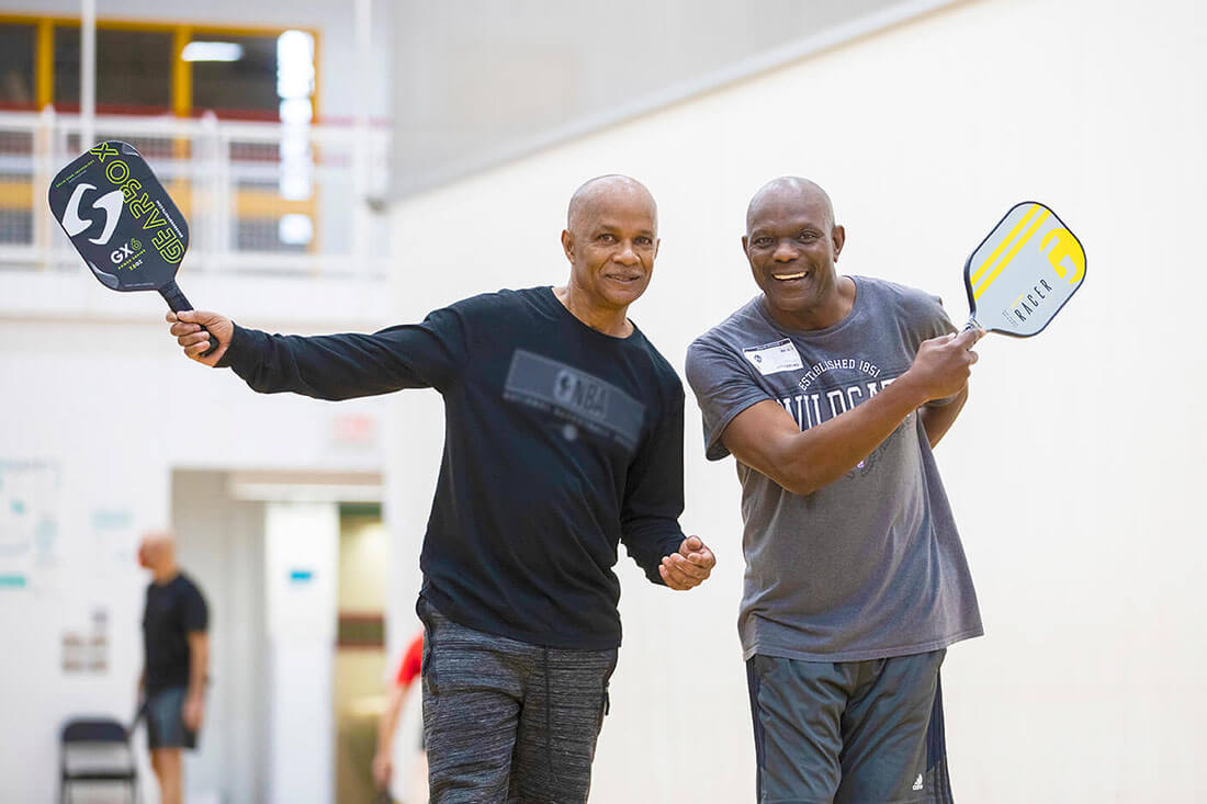 Two people playing pickleball at the YMCA.