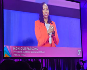 McGaw Y President/CEO Monique Parsons shown on a video screen at the General Assembly.