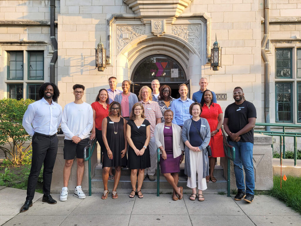 A group photo of the McGaw YMCA board standing outside of the YMCA.