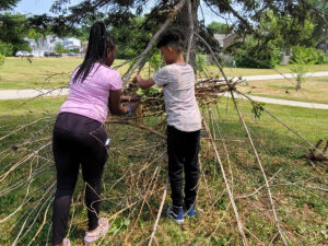 Meta Meets Camp youth building a tree canopy.