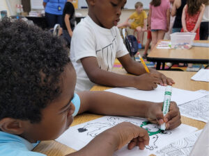 Summer Day Camp kids at McGaw YMCA drawing.