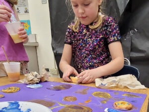 Summer Day Camp kids at McGaw YMCA doing arts and crafts.