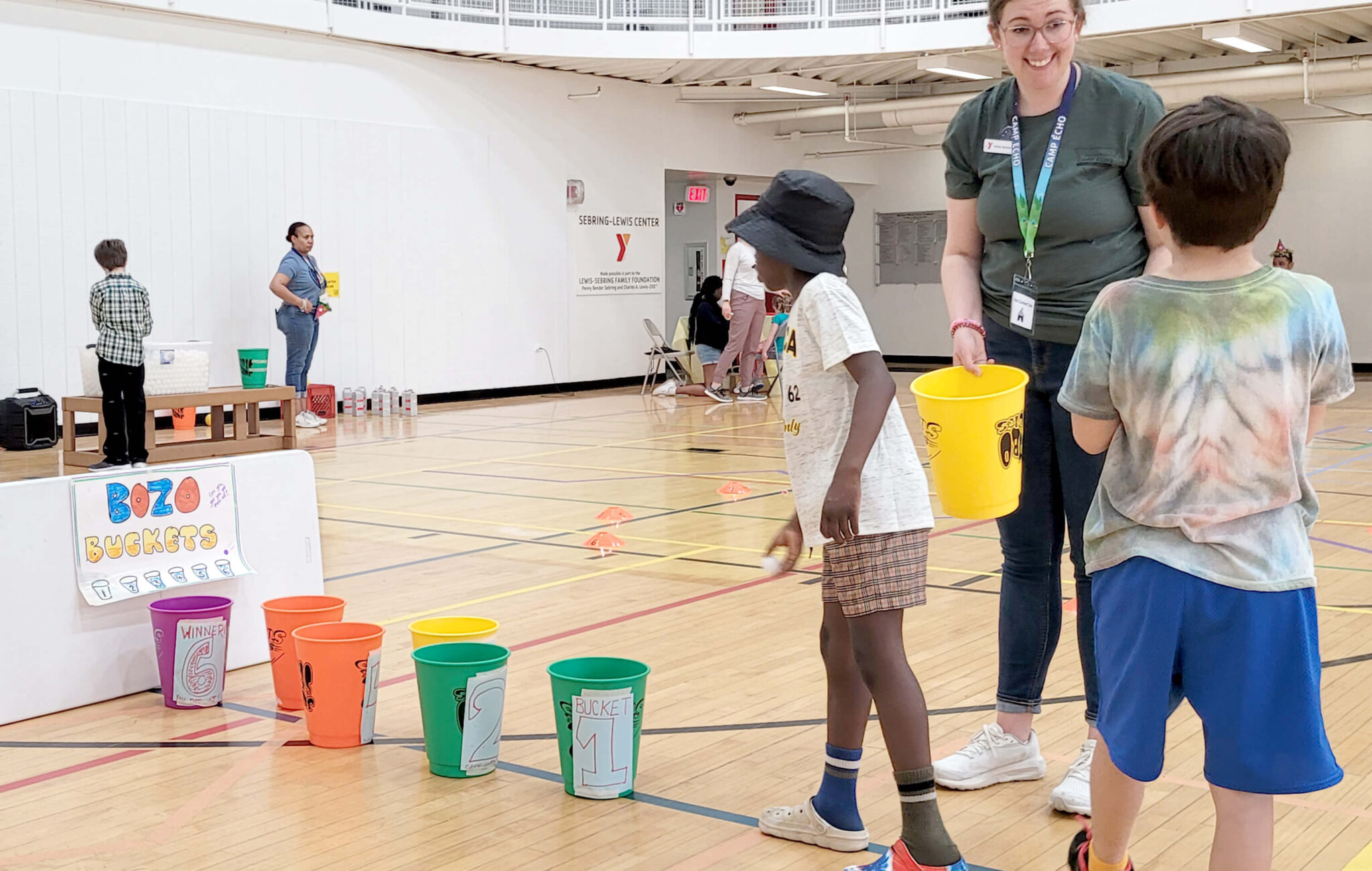 A child playing a carnival Bozo Buckets game