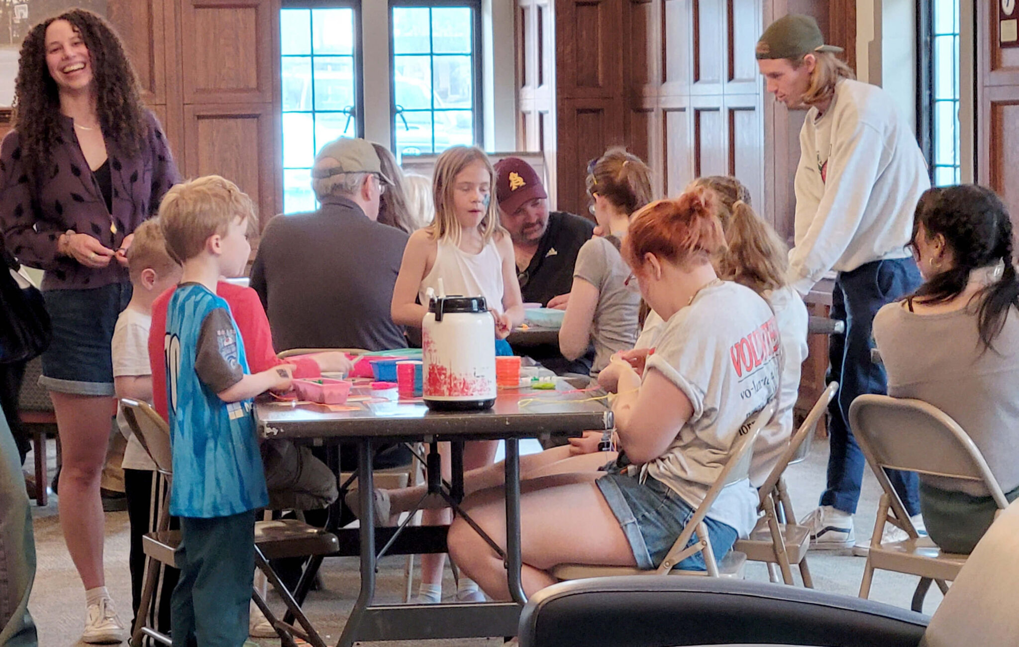 A group sitting around a craft table.