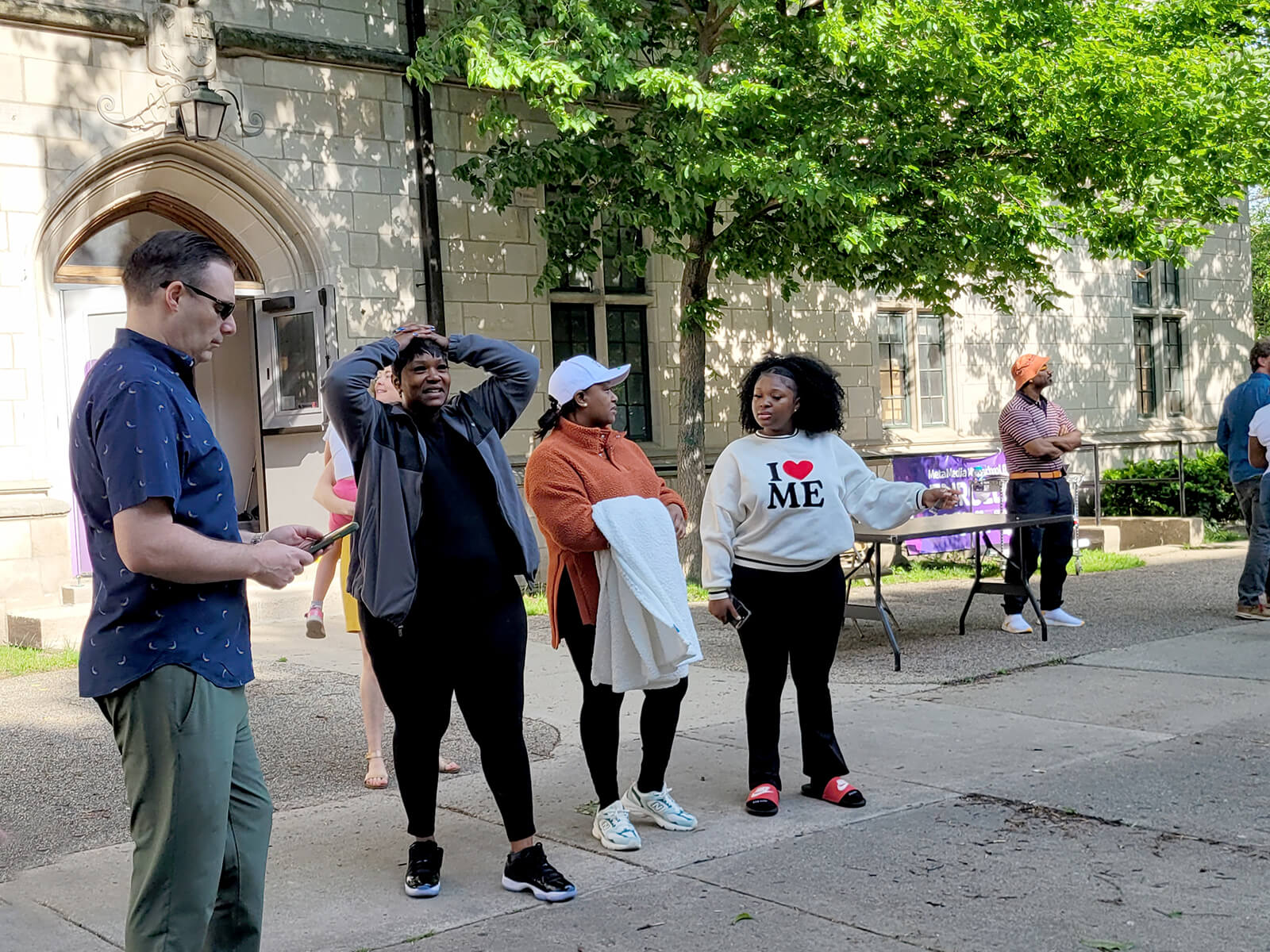 Several family members standing in anticipation of the bus departure.