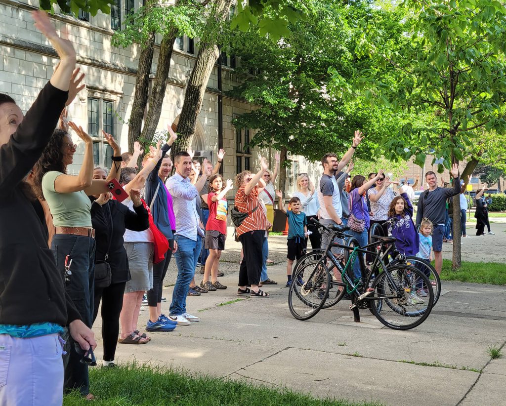Families waving to campers as they depart for Camp Echo