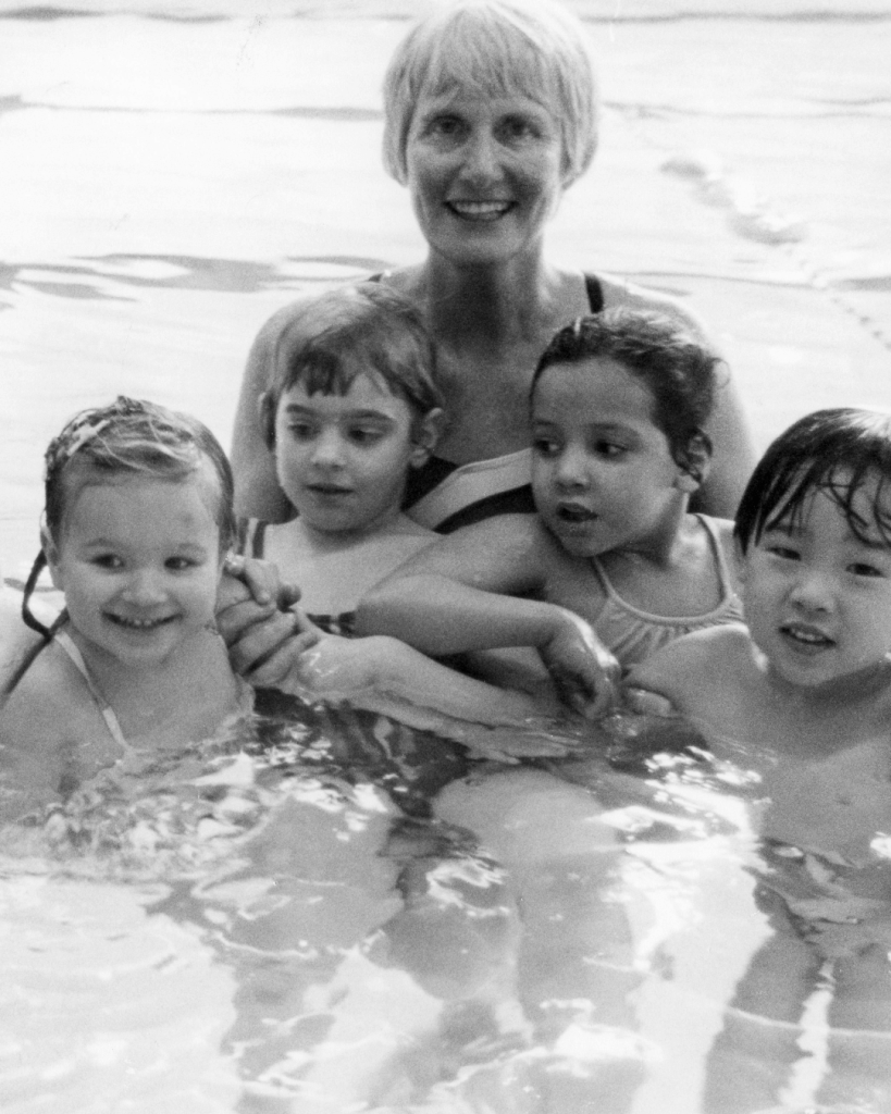 a photo of CK with swimmers in the pool