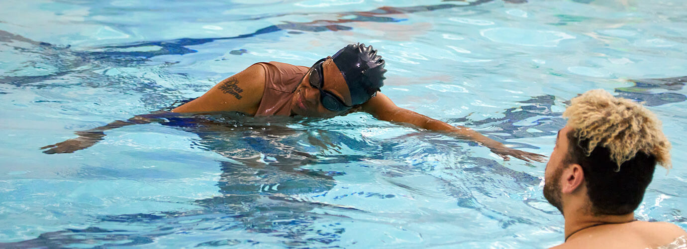 Adult learning to swim in pool