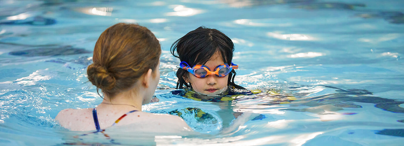 A young person learning to swim with private lessons.