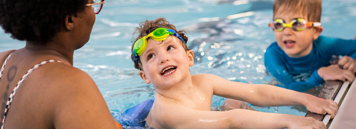 Two friends learning to swim together.