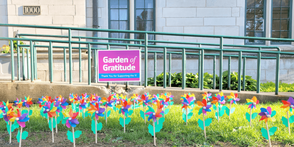 The Garden of Gratitude is pictured in front of the McGaw YMCA with numerous pinwheels in the grass in front of the Main Building.