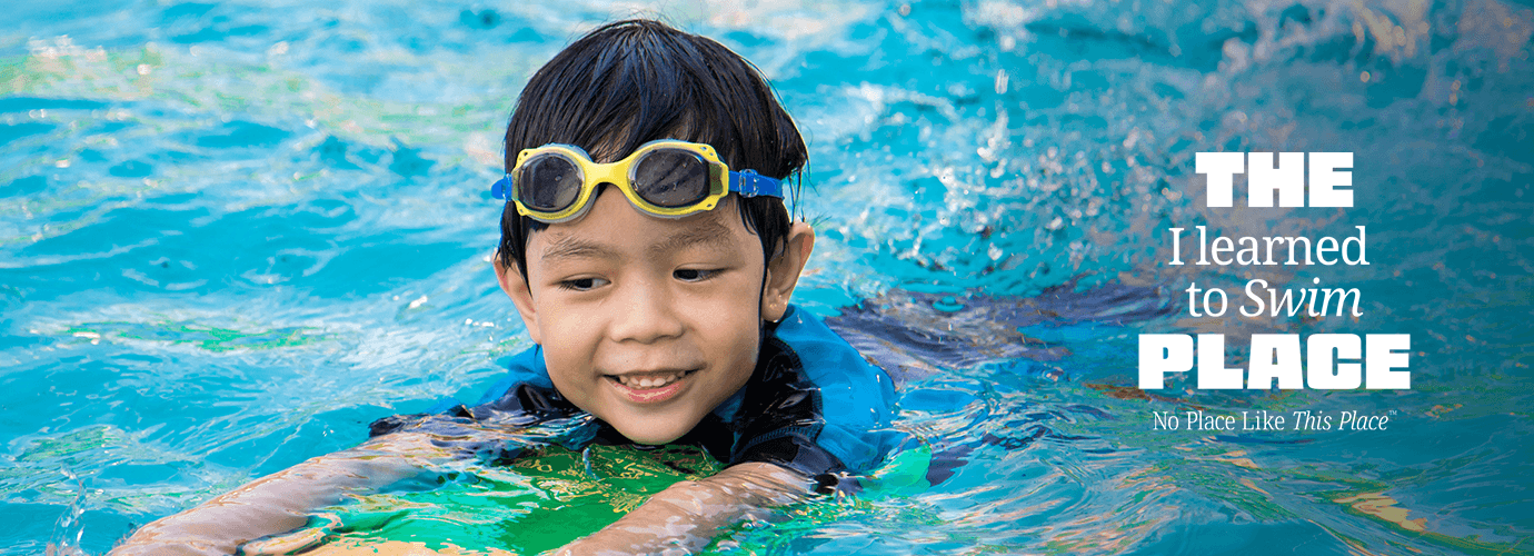 A child in the pool learning how to swim.