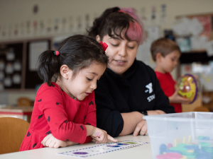 Young person in YMCA afterschool with teacher.