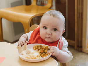 Mealtime with an infant at the Children's Center.