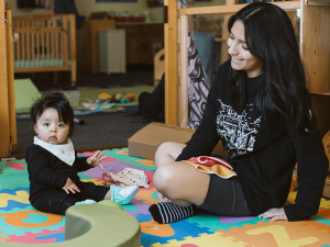 Rugtime with an infant at the Children's Center.