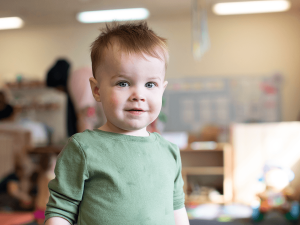 Toddler smiling at Children's Center